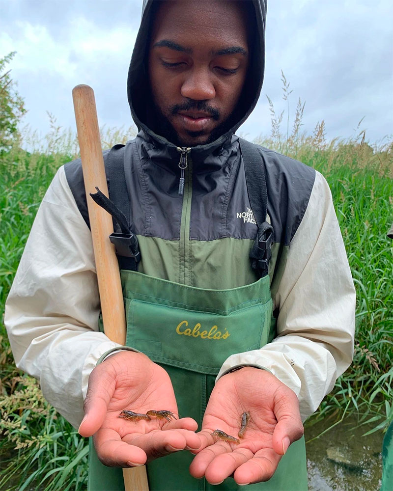 Virginia Tech Student inspecting crayfish
