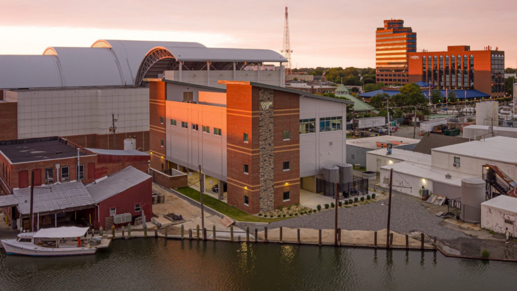 The Virginia Seafood AREC sits to the left of its previous building, nestled along Hampton’s working waterfront. Photo courtesy of RRMM Architects.
